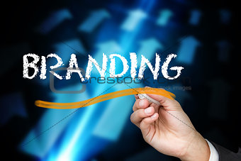 Businessman writing the word branding