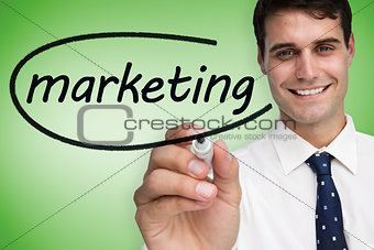 Businessman writing the word marketing