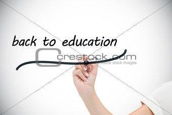 Businesswoman writing the words back to education