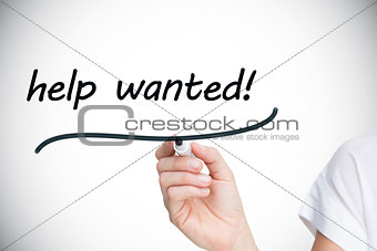Businesswoman writing the words help wanted