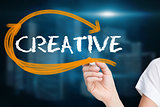 Businesswoman writing the word creative