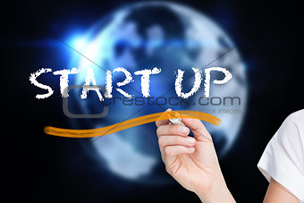 Businesswoman writing the word start up