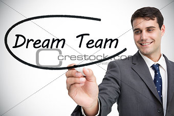 Businessman writing the words dream team