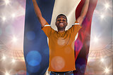 Composite image of cheering dutch football fan in orange jersey
