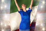 Composite image of cheering football fan in blue jersey holding italy flag