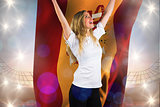 Composite image of pretty football fan in white cheering holding spain flag