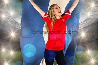 Composite image of cheering football fan in red holding honduras flag