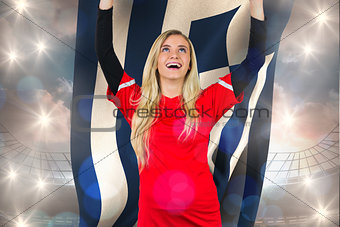 Composite image of cheering football fan in red holding greece flag