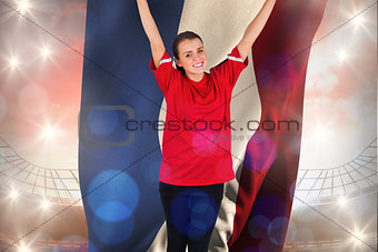Composite image of excited football fan in red cheering holding netherlands flag
