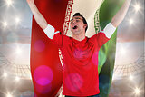 Composite image of excited football fan cheering holding iran flag
