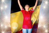 Composite image of cheering football fan in red holding belgium flag