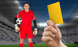 Composite image of hand holding up yellow card