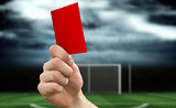 Composite image of hand holding up red card