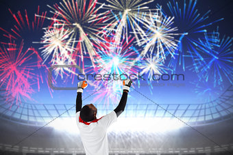 Composite image of excited goalkeeper in white cheering