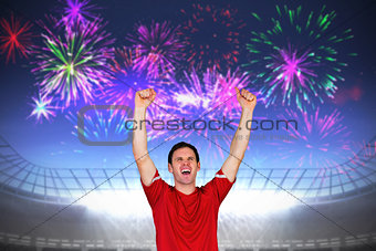 Composite image of cheering football fan in red