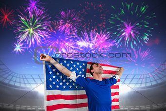 Composite image of american soccer fan holding flag