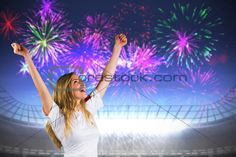 Composite image of pretty football fan in white cheering