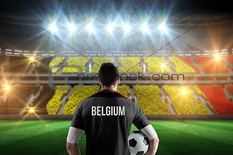 Composite image of belgium football player holding ball