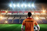 Composite image of netherlands football player holding ball