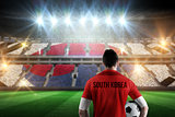 Composite image of south korea football player holding ball