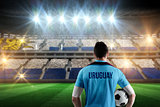 Composite image of uruguay football player holding ball