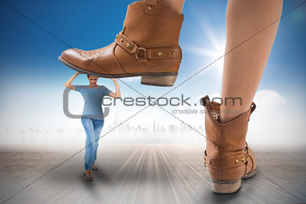 Composite image of cowboy boots stepping on girl