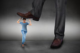 Composite image of businessman stepping on girl