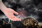 Composite image of businessman jumping holding an umbrella on large hand