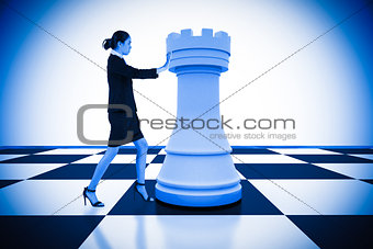 Composite image of businesswoman pushing chess piece