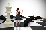 Composite image of redhead businesswoman in a blindfold