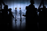 Composite image of silhouette of business people walking