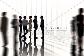 Composite image of business colleagues talking