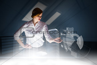 Composite image of redhead businesswoman using interactive desk
