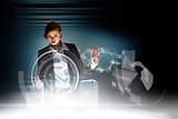 Composite image of redhead businesswoman using interactive desk