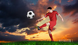 Composite image of football player in red kicking