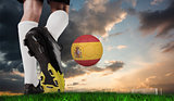 Composite image of football boot kicking spain ball