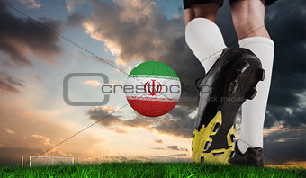 Composite image of football boot kicking iran ball