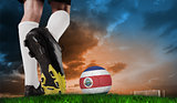 Composite image of football boot kicking costa rica ball