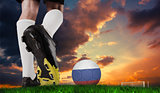 Composite image of football boot kicking russia ball