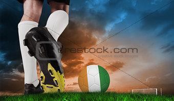 Composite image of football boot kicking ivory coast ball