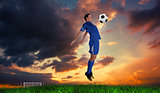 Composite image of football player in blue jumping