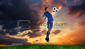 Composite image of football player in blue jumping