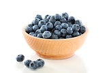Blueberry fruit in a wooden bowl .