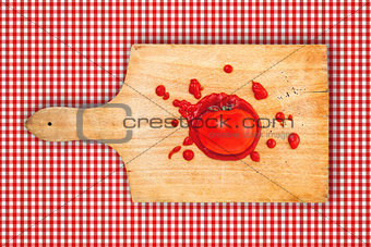 Tomato and ketchup on wooden board