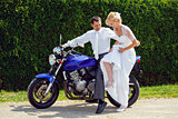 beautiful young wedding couple on motorcycle