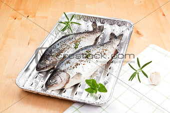 Fish on grilling tray ready for barbecue.