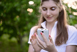 Young Beautiful Woman Using her Smart Phone Outdoor