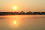 Sunrise at Kavango river whit mist on the water surface