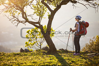 Female hiker standing on cliff and enjoying view