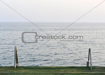 Wooden pier with metal handrails